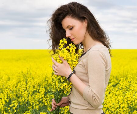 girl portrait in yellow flower field