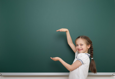 Schoolgirl near the school boardの写真素材