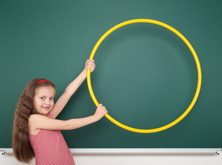 Schoolgirl near the school boardの写真素材