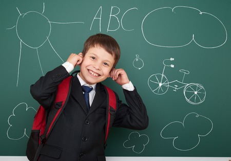 school boy drawing fun object on boardの写真素材