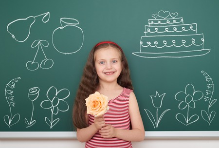 girl with draw flowers and other object on boardの写真素材