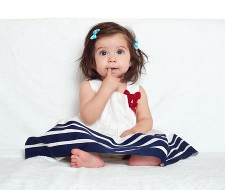 baby girl portrait, sit on white towelの写真素材