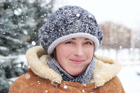 Woman portrait at winter season with snowy fir treesの写真素材