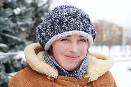 Woman portrait at winter season with snowy fir trees
