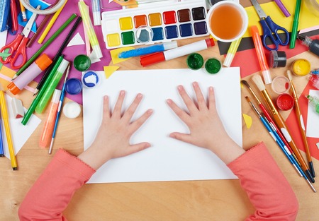 Child drawing top view. Artwork workplace with creative accessories. Flat lay art tools for painting.の写真素材