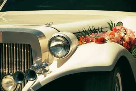 White wedding limousine decorated with flowersの写真素材