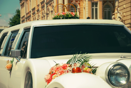 White wedding limousine decorated with flowersの写真素材