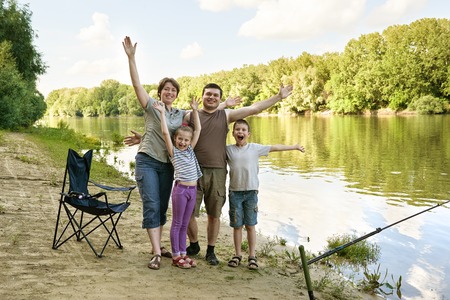 family camping and fishing, river and forest, summer seasonの写真素材