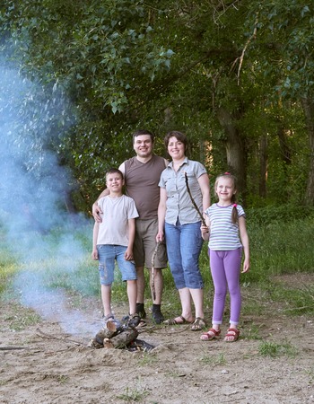 people camping in forest, family active in nature, kindle fire, summer seasonの写真素材