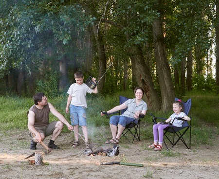 people camping in forest, family active in nature, kindle fire, summer seasonの写真素材