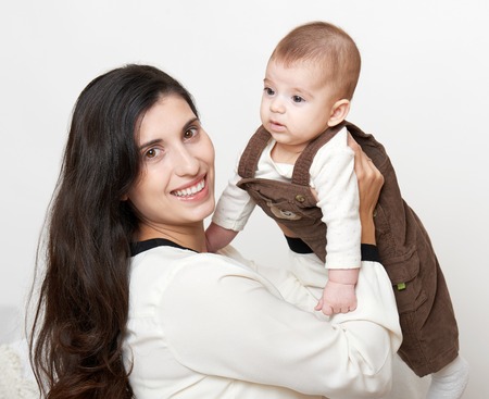 Mother and baby, happy family portrait on white background