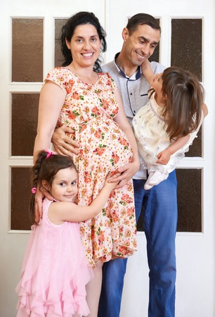 family with children indoor portrait, pregnant woman and man, beautiful people portraitの写真素材