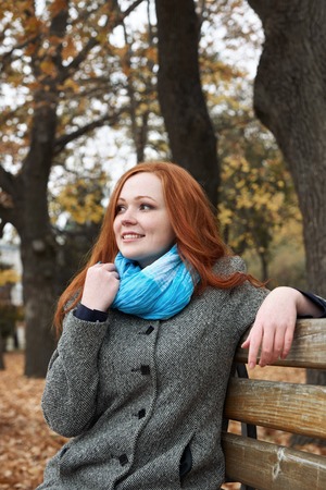 young woman portrait in autumn park, yellow leaves and treesの写真素材