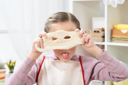 Cooking at home, girl in kitchen, making dough, healthy food conceptの写真素材