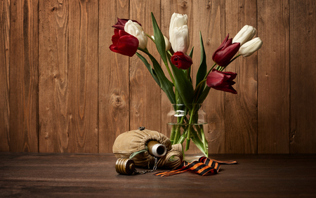 old soldier's flask and St. George's ribbon on wooden background, world war II memorial concept and fallen warriorsの写真素材