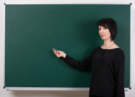 teacher show anything on chalk board, learning concept, green background, Studio shotの写真素材