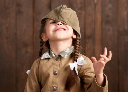 child girl are dressed as soldier in retro military uniformsの写真素材