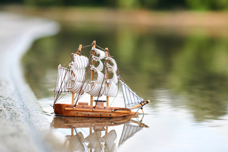 a toy sailing ship in the riverの写真素材