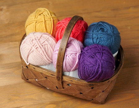 Colorful wool threads for knitting on wooden backgroundの写真素材