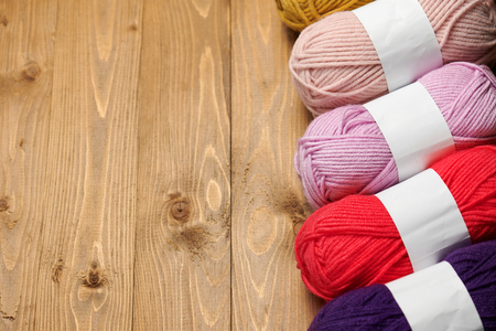 colorful wool threads for knitting on wooden backgroundの写真素材