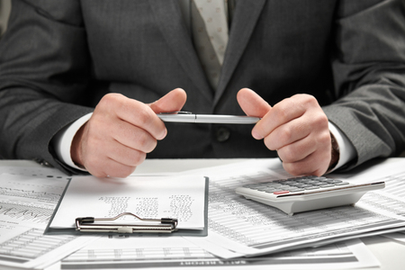 Businessman working in an office. Hands and documents closeup.の写真素材