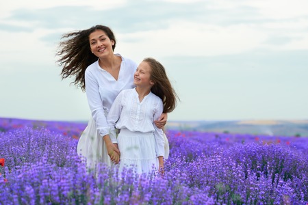 girls are in the lavender flower field, beautiful summer landscapeの写真素材