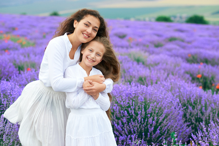 girls are in the lavender flower field, beautiful summer landscapeの写真素材