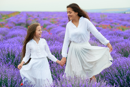 girls are in the lavender flower field, beautiful summer landscapeの写真素材