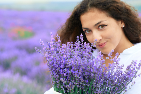 beautiful woman face with lavender flowerの写真素材