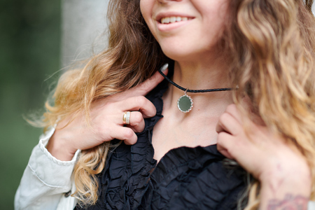 beautiful girl shows necklace close upの写真素材