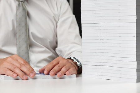 Businessman working at an office, reads stack of books and reports. Business financial accounting...