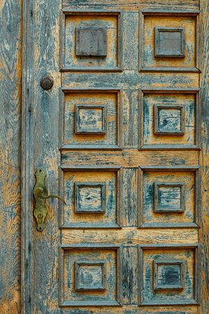 vintage wooden door and old white wall as backgroundの写真素材
