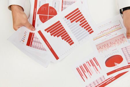 Flat top view of businessman working and calculating finance, reads and writes reports. Business...