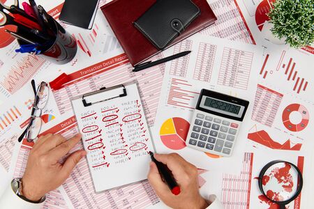 Business reports, data tables and charts - directly above view of office table workspace.の写真素材