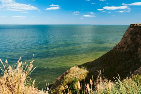 Wild sea coast, wave and hill - beautiful summer landscape and travel concept, bright day and sky...