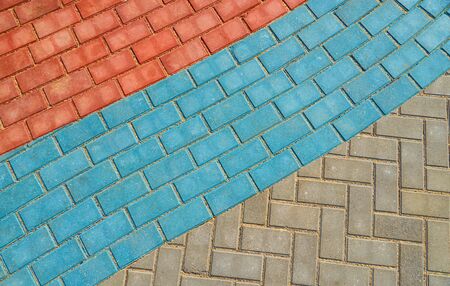 red and blue paving tiles for background or textureの写真素材
