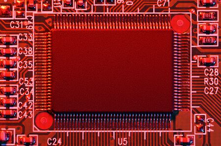 printed circuit board and microchip, or cpu, in red light closeup - electronic component for digital...