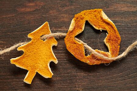 Handmade decoration from dried fruits on a dark wood background. Top view.の写真素材