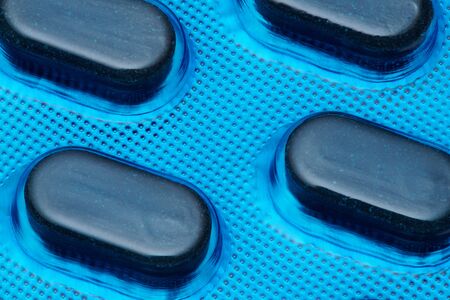 Blue tablets in blister pack arranged with beautiful pattern. Global healthcare concept. Antibiotics drug resistance. Antimicrobial capsule pills. Pharmaceutical industry. Pharmacy.の写真素材