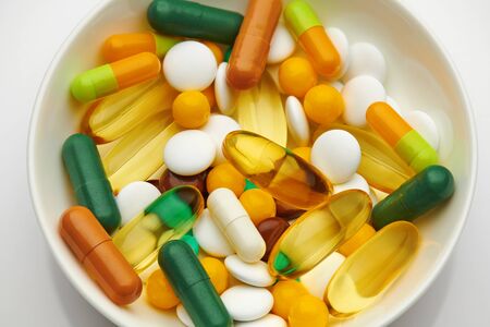 Plate with set of pills, tablets, vitamins, drugs, omega 3 fish oil, gel capsules, medicament and food supplement for health care. Pharmaceutical industry. Pharmacy.の写真素材