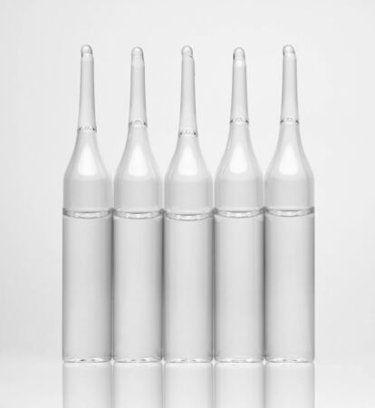 Ampoules. Transparent capsules with liquid on white background. Medicament for health care. Pharmaceutical industry. Pharmacy.の写真素材