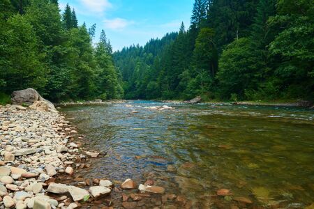 landscape, beautiful view of mountain river in summer day, fast flowing water and rocks, wild nature