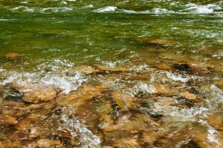 landscape, beautiful view of mountain river in summer day, fast flowing water and rocks, wild nature