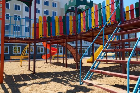 Urban residential infrastructure without people - children's playground next to a condominium....