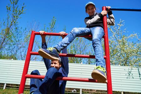 Children play on the playground next to a condominium. A place for children to play. Urban residential infrastructure.の写真素材