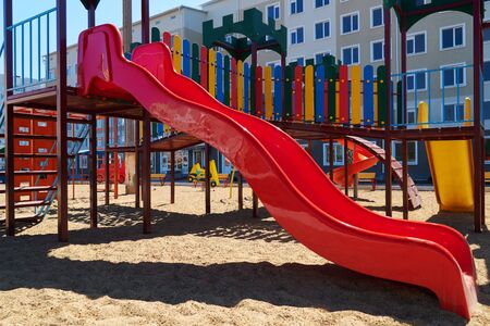 Urban residential infrastructure without people - children's playground next to a condominium....