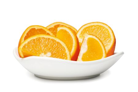 Fresh cut orange fruits on a plate macro photo, isolated on white backgroundの写真素材