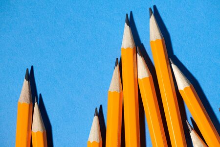 graphite pencils on a blue background macro photo, school and office suppliesの写真素材