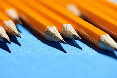 graphite pencils on a blue background macro photo, school and office supplies