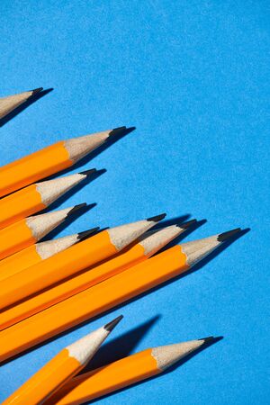 graphite pencils on a blue background macro photo, school and office supplies